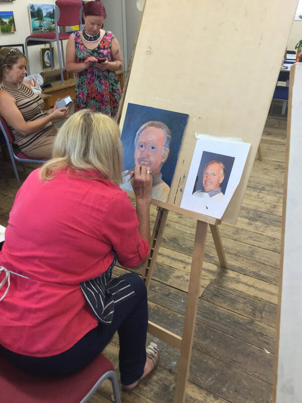 A member of Yate and Chipping Sodbury Art and Craft group painting a portrait during one of the evening meetings 